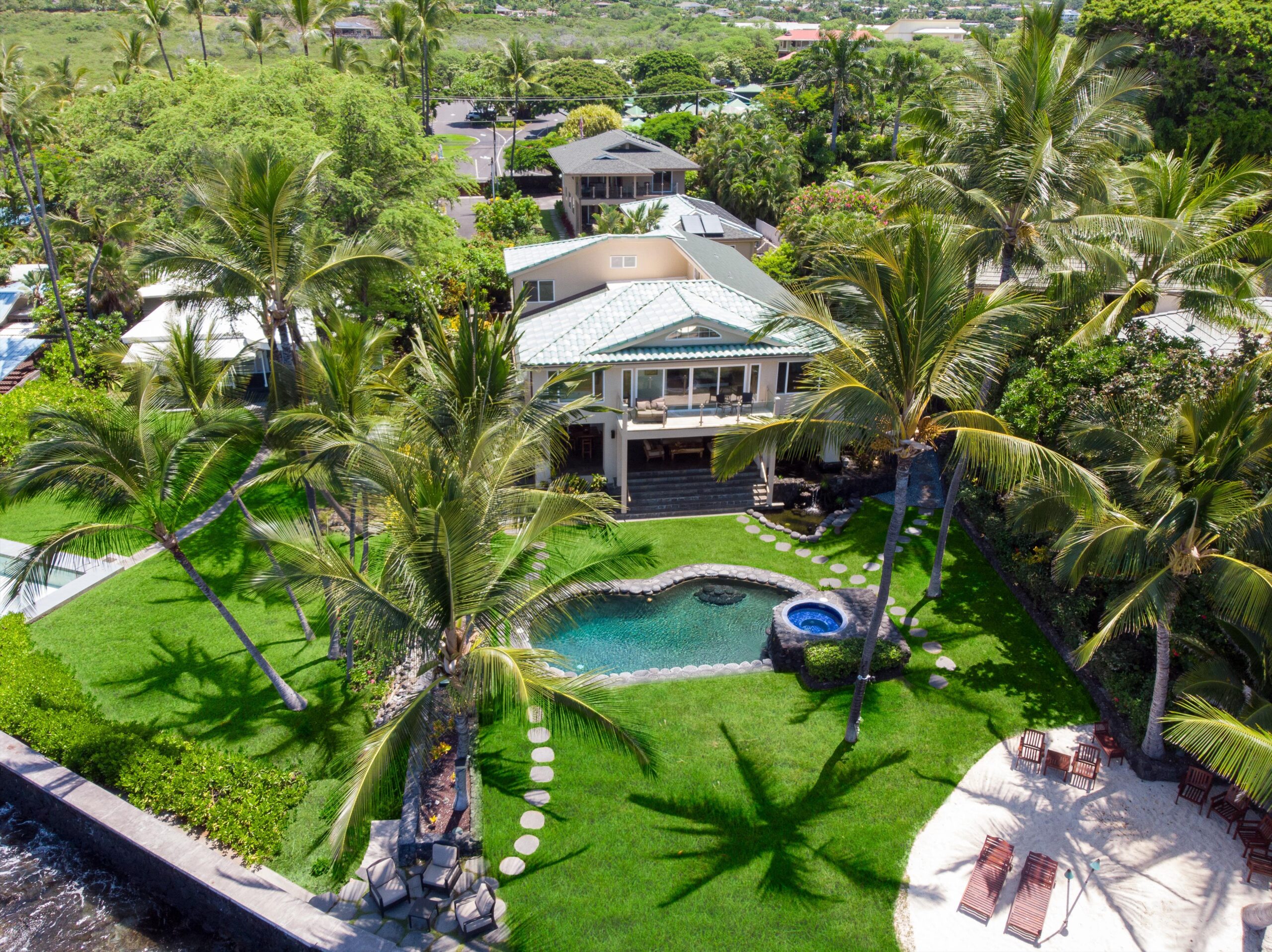 Aerial view of the Kona Beach Bungalows estate, pool and shoreline