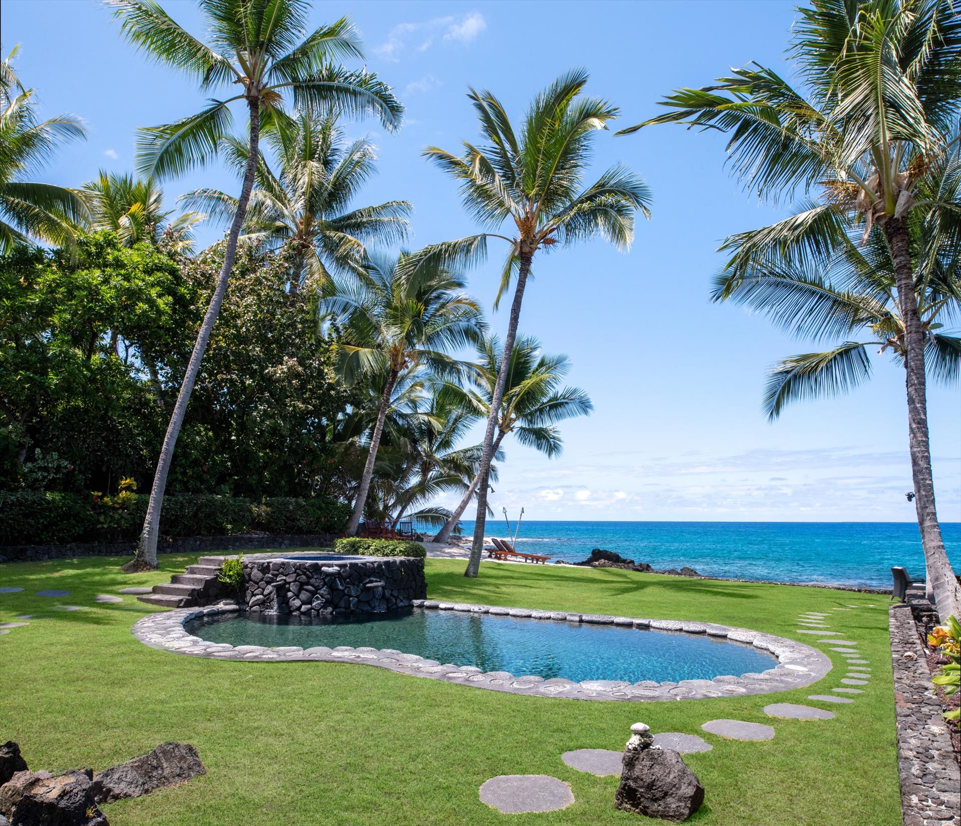Freshwater pool and lava rock spa on the oceanfront lawn